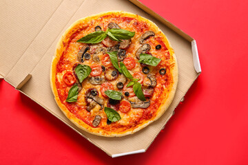 Cardboard box with tasty pizza on color background