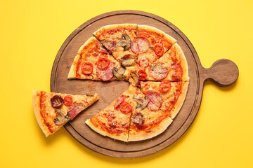 Board with tasty pizza on color background