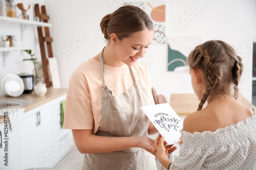 Little girl greeting her mom on Mother's Day at home