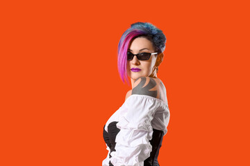 Portrait of extravagant stylish woman on color background