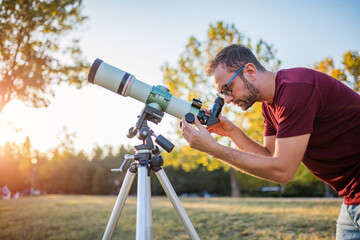 Amateur astronomer looking at the sky with a telescope.