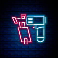 Glowing neon line Nail gun icon isolated on brick wall background. Colorful outline concept. Vector