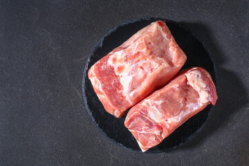 Raw pork loin. Pork meat on a gray background. Top view. Copy space.
