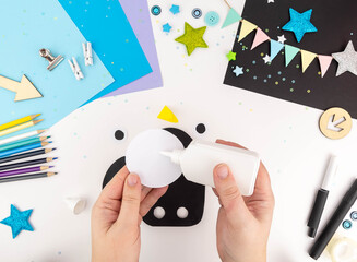 Step-by-step instruction of making a penguin out of paper with children. Step 3