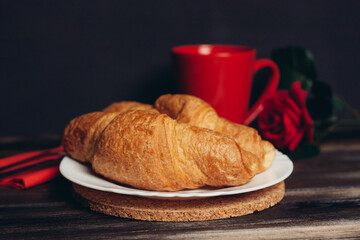 crispy croissants on a plate wooden table coffee mug breakfast