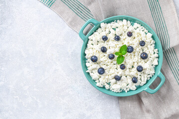 Cottage cheese with berries and mint. Cottage cheese in a bowl. Top view. Dairy products.