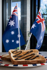 Vegemite on Toast. Iconic Traditional Australian Breakfast Staple.  Anzac or Australia Day food flag in the background, with blue skies.