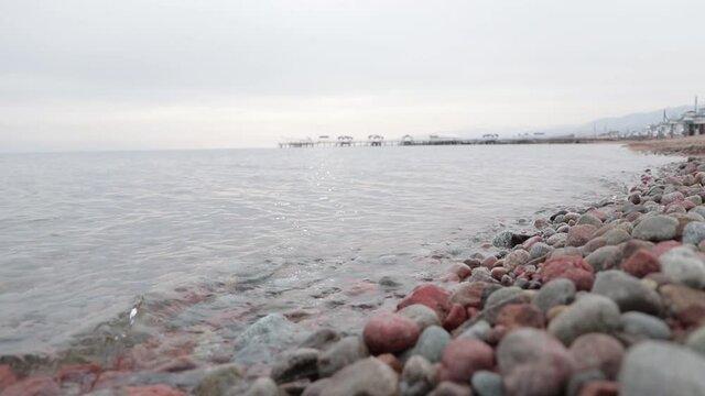 Pebble shore in cloudy weather.