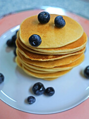 Traditional American or Canadian blueberries pancakes served on plate, food concept
