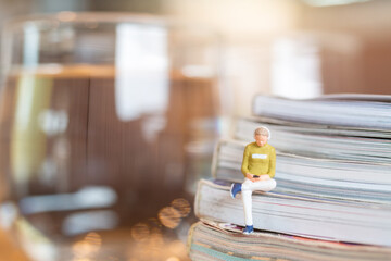 Miniature people Woman wearing headphones and listening to music