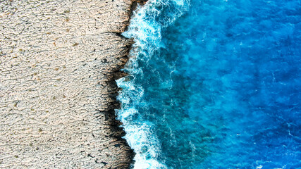 View from the height of the coastal contrast line of the surf. Water and drought.