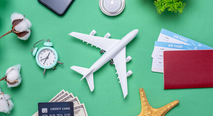 Miniature of an airplane, tickets and passport, and travel accessories. Vacation and ticket booking concept