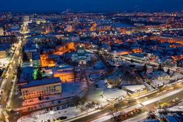 Fototapeta na wymiar Beautiful evening top view of the city. Evening, night illumination in the city. Winter city in the snow.