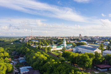 Kirov and the high bank of the river Vyatka and the Alexander Grin Embankment and Trifonov Monastery on a sunny summer day.