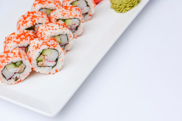 Sushi set with caviar on the white plate over white background. Traditional Japanese cuisine concept.