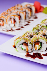 Maki Sushi Rolls made of smoked eel, cream cheese and unagi sauce. Traditional Japanese cuisine concept.