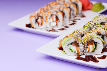 Maki Sushi Rolls made of smoked eel, cream cheese and unagi sauce. Traditional Japanese cuisine concept.