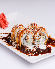 Maki Sushi Rolls made of smoked eel, cream cheese and unagi sauce. Traditional Japanese cuisine concept.