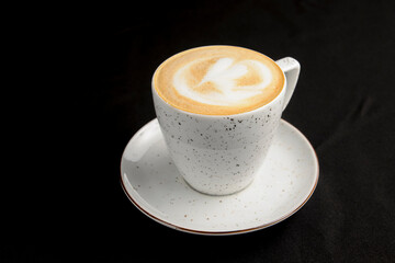 Cup of americano coffee with milk over black background. Coffeee time, isolated on black.