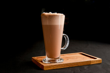 Hot chocolate with marshmallows isolated on black background. Glass of cocoa over black.