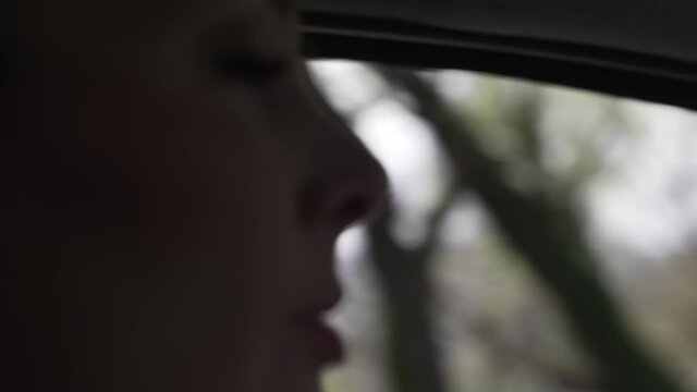 Portrait of woman driving car, slow-motion