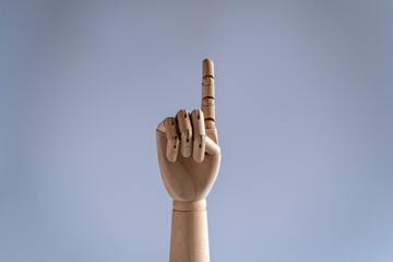 Wooden mannequin hand showing numbers