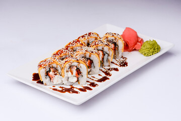 Sushi small set served on a white plate over white background. Traditional Asian Japanese cuisine concept.