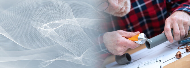 Fototapeta premium Plumber applying glue on pvc pipe; panoramic banner