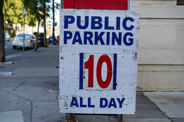 Worn out Public parking all day for $10 sign