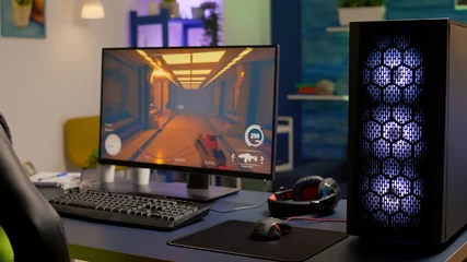 Fotobehang Gaming Empty room with nobody in it with professional gaming equipment. Pro gamer using powerful computer for first person shooter video game during online competition  © DC Studio