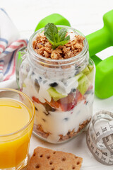 Healthy breakfast with jar of granola, yogurt and fresh berries
