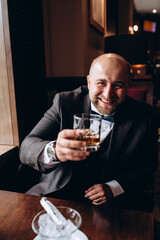 Successful businessman at a table in a restaurant.