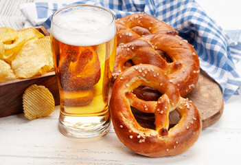 Lager beer, potato chips and fresh homemade pretzel