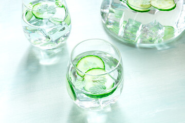 Cucumber and mint drinks with ice on a rustic blue background