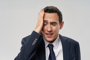 puzzled man in a suit touching his head with his hand problems at work