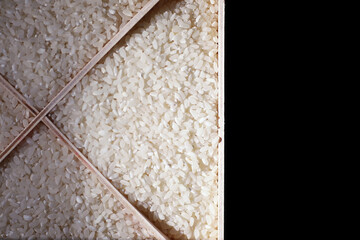 A set of grain cereals. Rice, buckwheat and millet groats in a wooden tray. A grocery set of cereals. Import of grain.