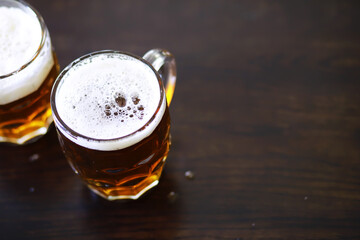 Glass of fresh beer on a wooden table. Lager beer mug on stone table. Top view with copy space