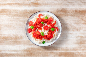 Konjac pasta, a healthy vegan dish, with tomato sauce and basil, shot from above