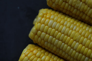 Freshly made fragrant ear of corn with salt. Farm snack of fresh corn. Healthy breakfast and healthy lifestyle concept.