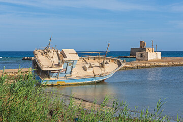 Old derelict shipwrecked boat abandoned on beach