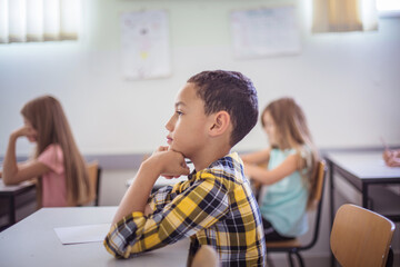 Concentration on class.  Teenagers students sitting in the classroom.