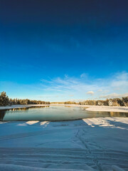 Frozen Lake in Swedish Taiga with Forests and Sunset