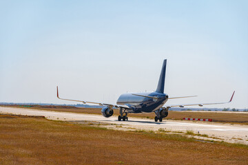 Fototapeta na wymiar Big passenger airplane drives along the runway in airport