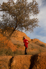 Fototapeta premium Stylish pregnant woman. Beautiful young pregnant woman enjoying the sunset. Pregnant tummy. The pleasure of pregnancy. Life style. Motherhood.Maternity.