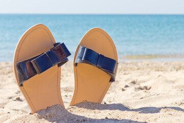 women's sandals on a sandy beach
