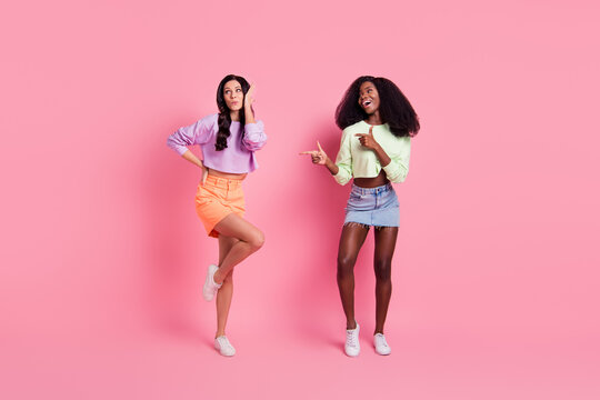 Full length body size view of attractive cheerful girls dancing having fun good mood rest isolated over pink pastel color background