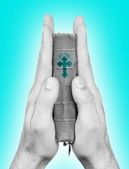 Fototapeta premium Praying hands holding the old bible