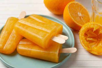 orange popsicles on a plate