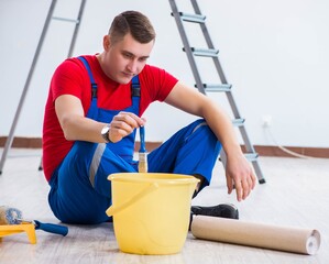 Male painter preparing for painting job at construction site