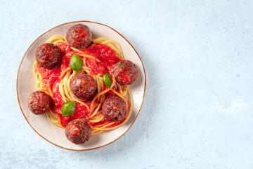 Meatballs and pasta with tomato sauce, shot from the top